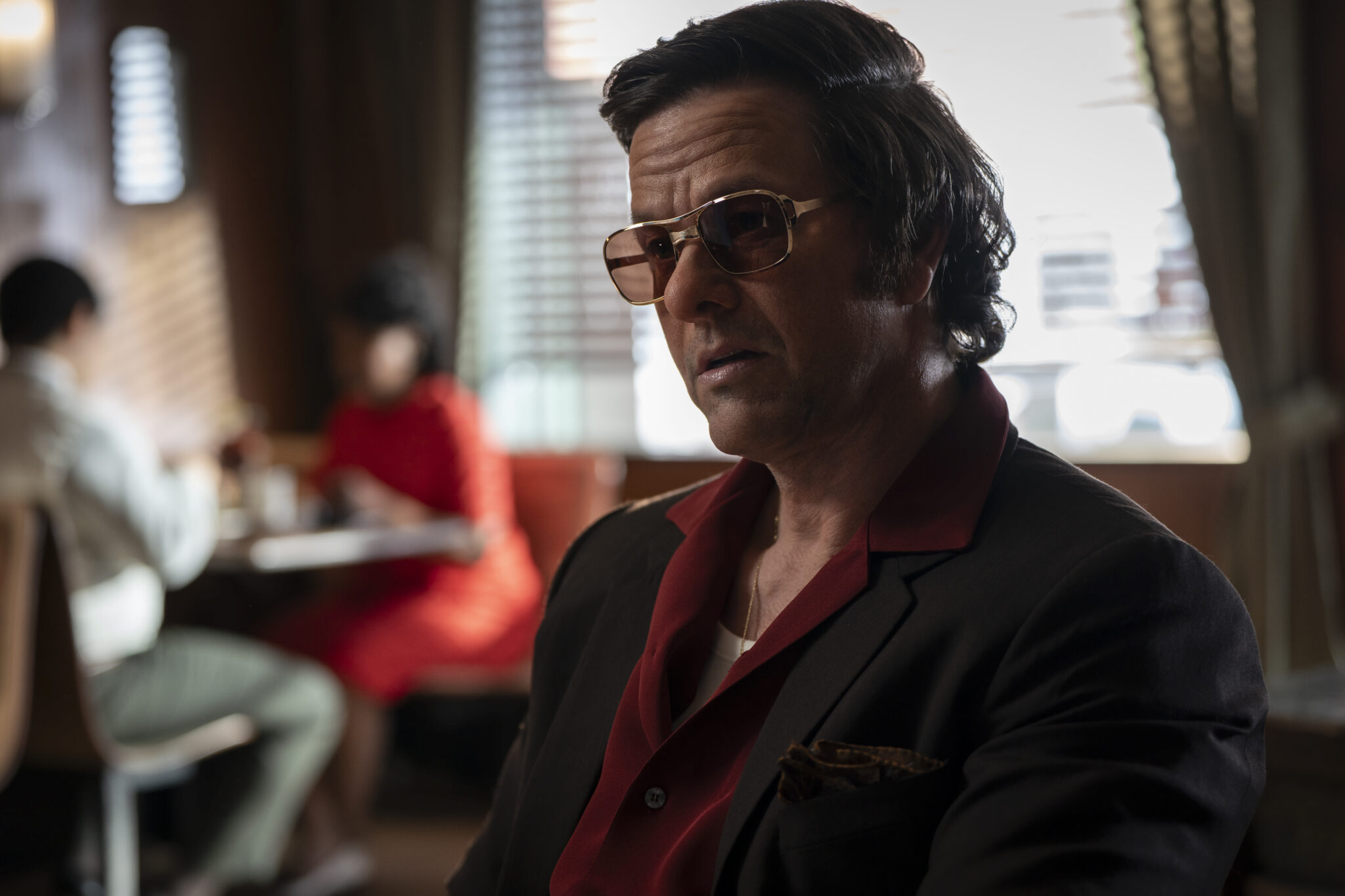 Mark Wahlberg seated in a diner in an official still from By Any Means (2026)