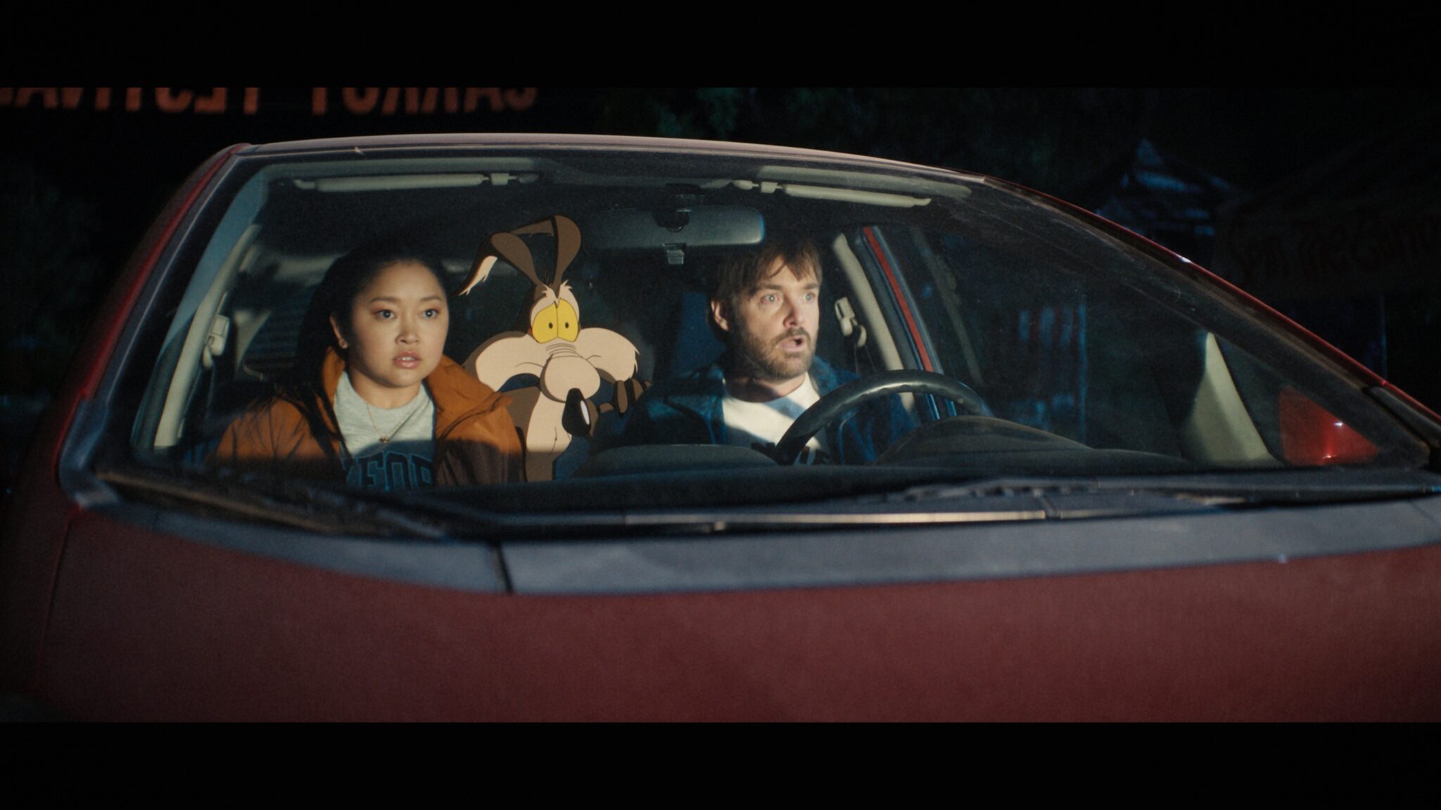 Lana Condor, Will Forte and Wile E. Coyote in a car in Coyote vs. Acme (2026)