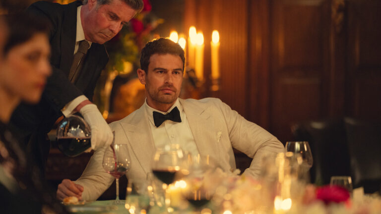 A guest at an elegant candlelit dinner in The Gentlemen season two