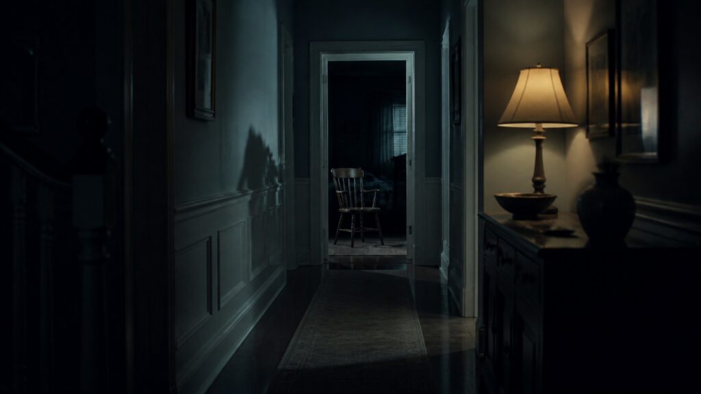 Original editorial illustration of a dimly lit hallway leading to an empty chair