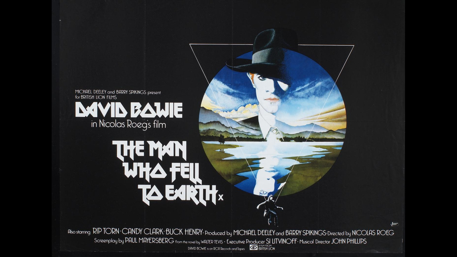 Original UK quad poster for The Man Who Fell to Earth: David Bowie in a black fedora inside a circle of blue sky, mountains and a lake, set in a white triangle on a black background beside the film’s angular title lettering