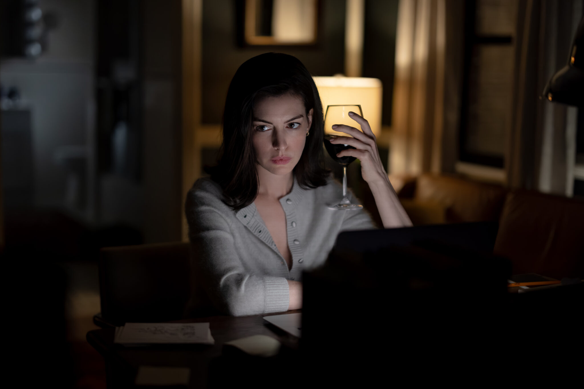 Verity (2026): Anne Hathaway as Verity Crawford in a dim room